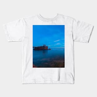 A rock stack creeping out of the blue ocean Kids T-Shirt